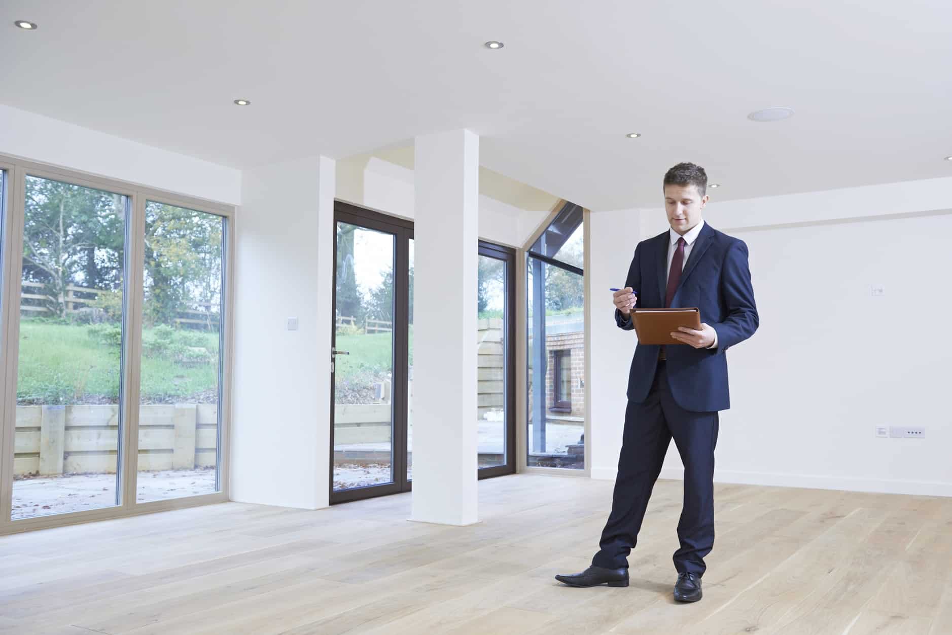 Property Valuation Man With Notebook and Pen in House | Taxwise Australia | (08) 9248 8124